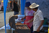 A man and a woman grill some meat for vending - Portobello, Colón, Panama - photo by H.Olarte