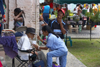 A woman feeds an old man - in the Panamanian tradition, the elders are cared for by the younger relatives - Portobello, Colón, Panama - photo by H.Olarte