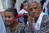 Two old ladies in traditional mourning clothes watch the dances at the  meeting of congos and devils, Portobello, Colón, Panama, Central America - photo by H.Olarte
