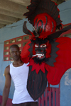 A congo culture man shows a devil mask, which represents the 'oppresor' white Spanish man, during the bi annual meeting of Devils and Congos, Portobello, Colón, Panama, Central America - photo by H.Olarte